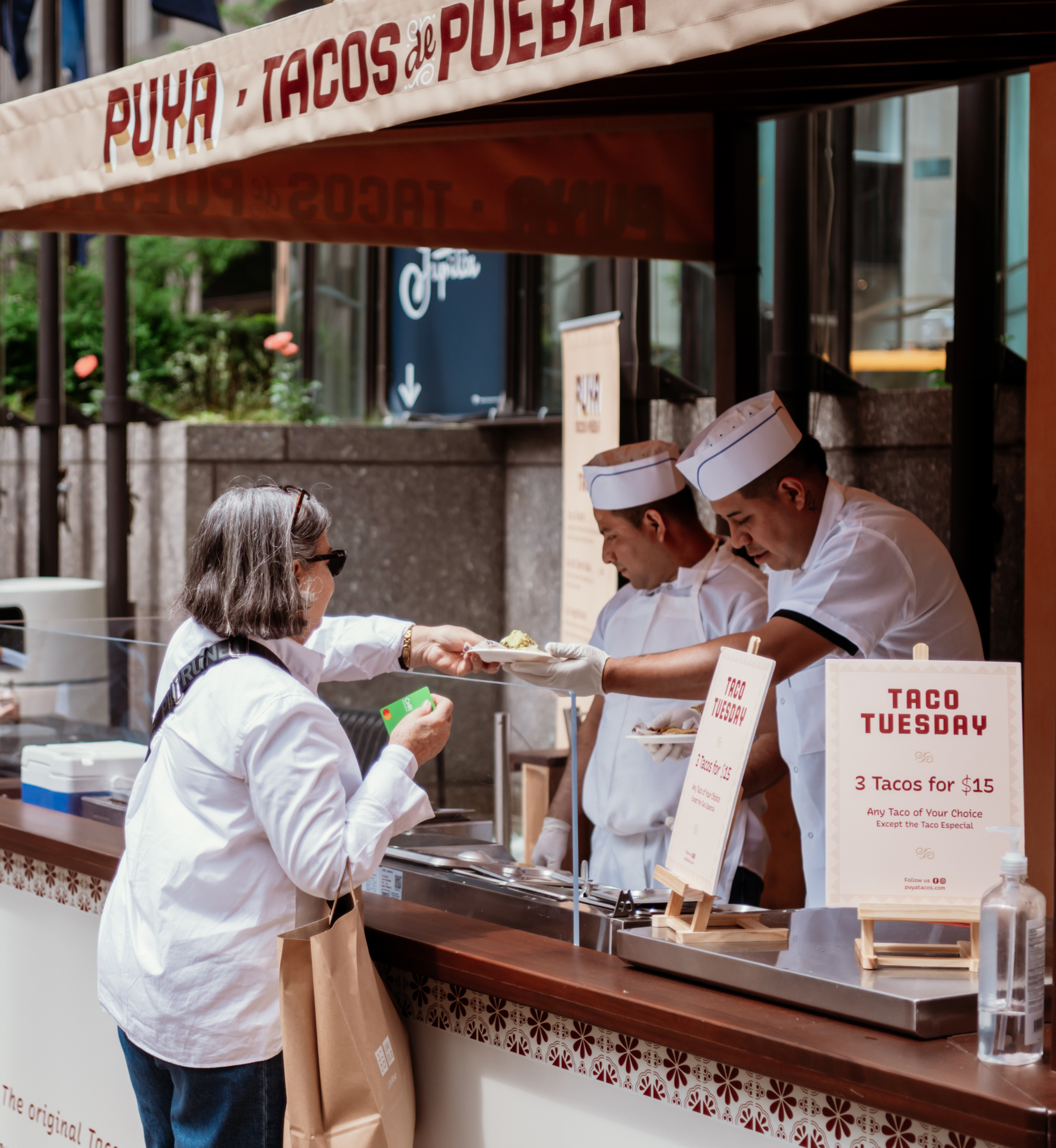 Woman ordering food from Puya Tacos' food truck at Rockefeller Center