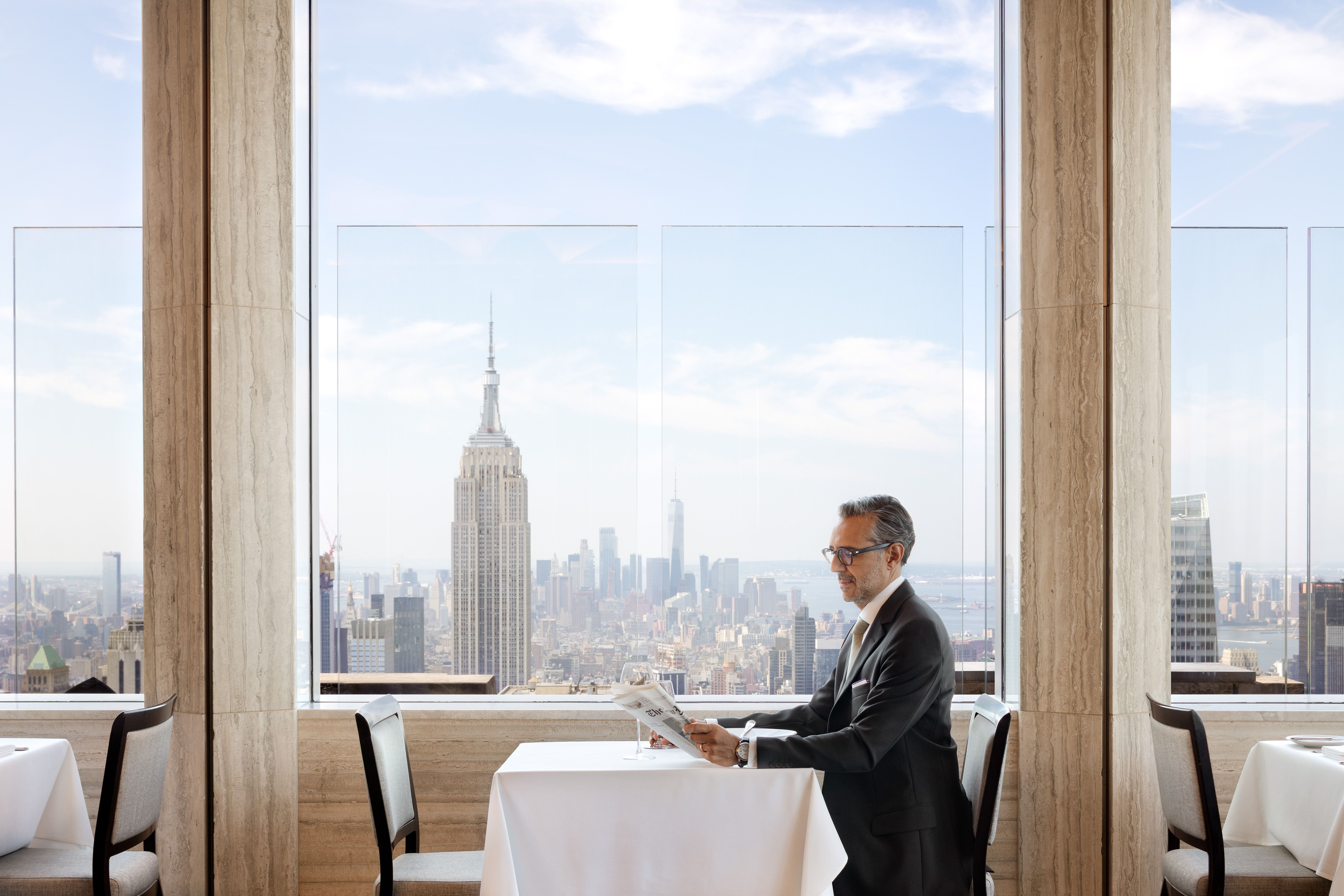 man sitting at table at window