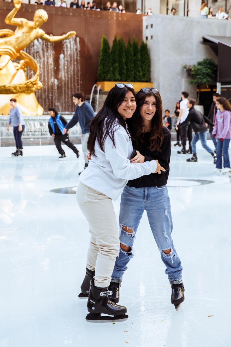 two girls ice skating on the rink at Rockefeller center