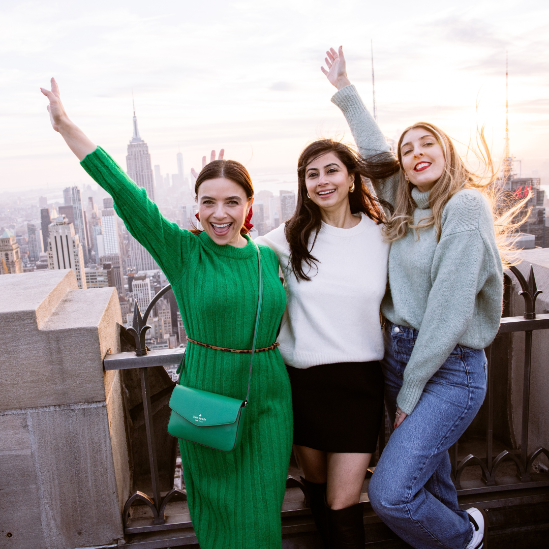 visitors posing at top of the rock observation deck