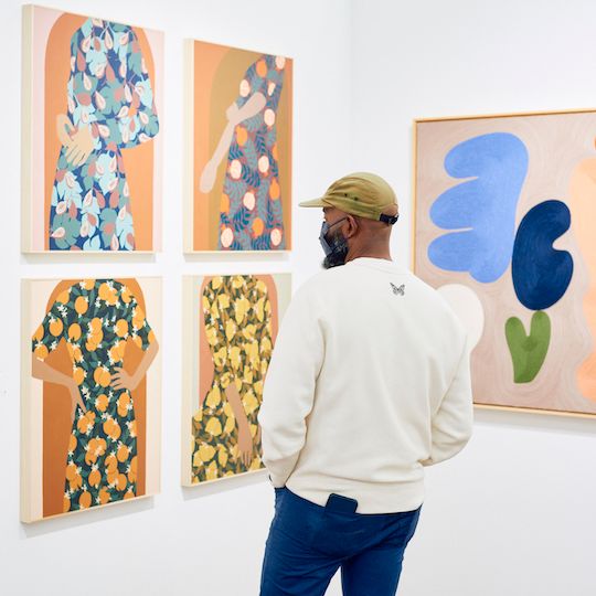 Person looking at a series of photos at the Affordable Art Fair