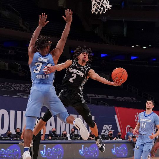 Basketball players on the court during the Big East Tournament