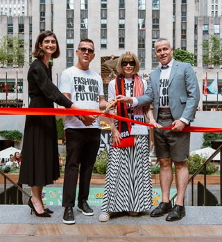Four people cutting a red ribbon to mark the start of New York Fashion Week at Rockefeller Center