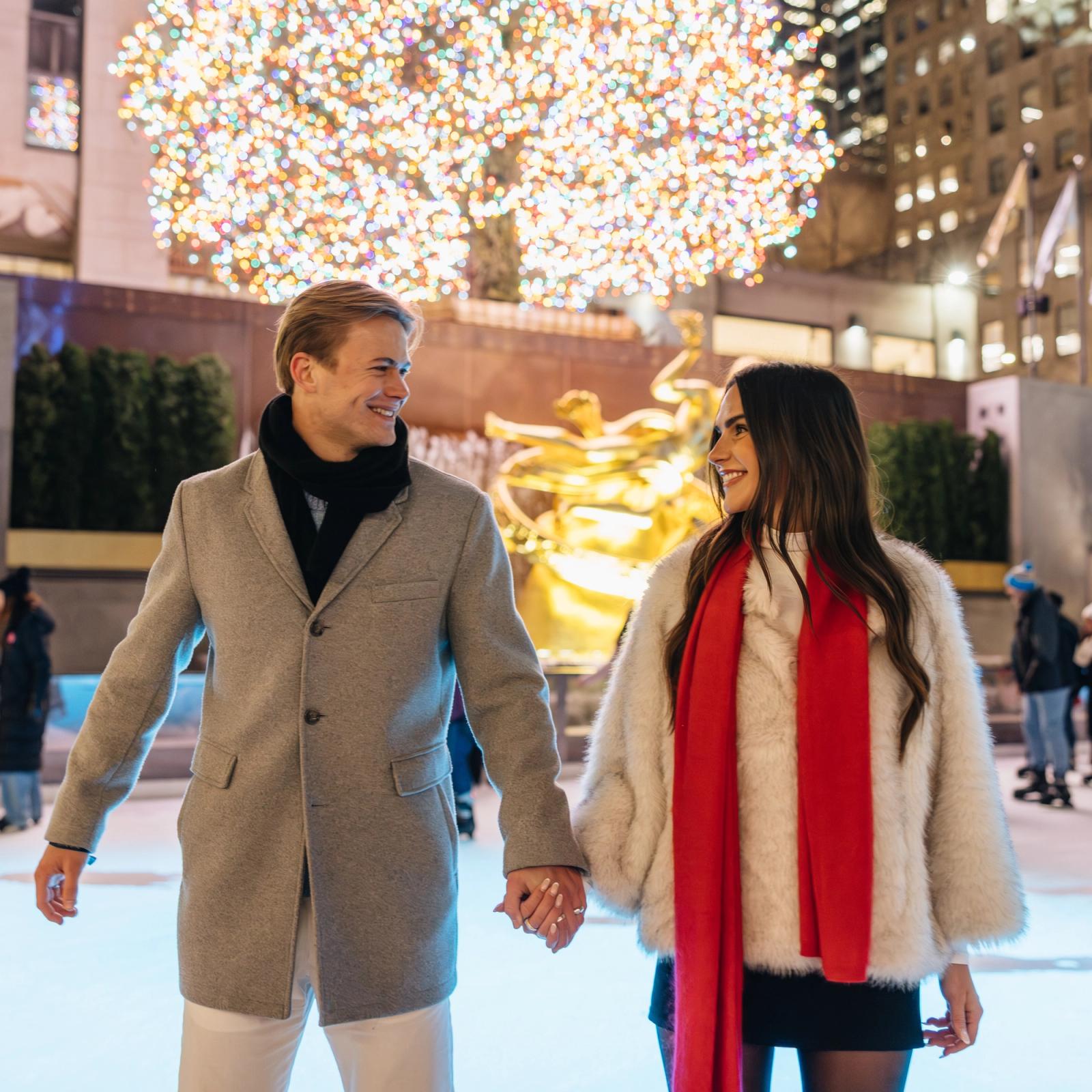 two people holding hands on the ice rink