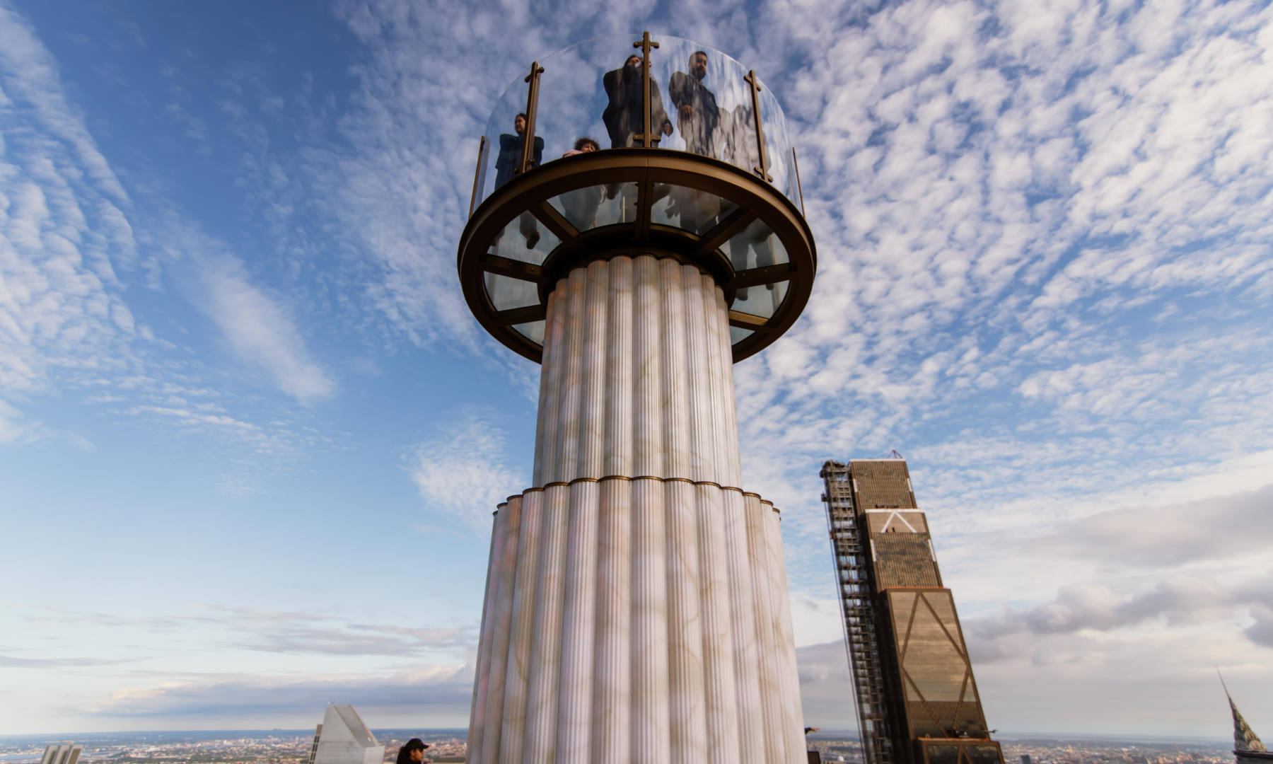 People standing on Skylift's glass platform while suspended in the air