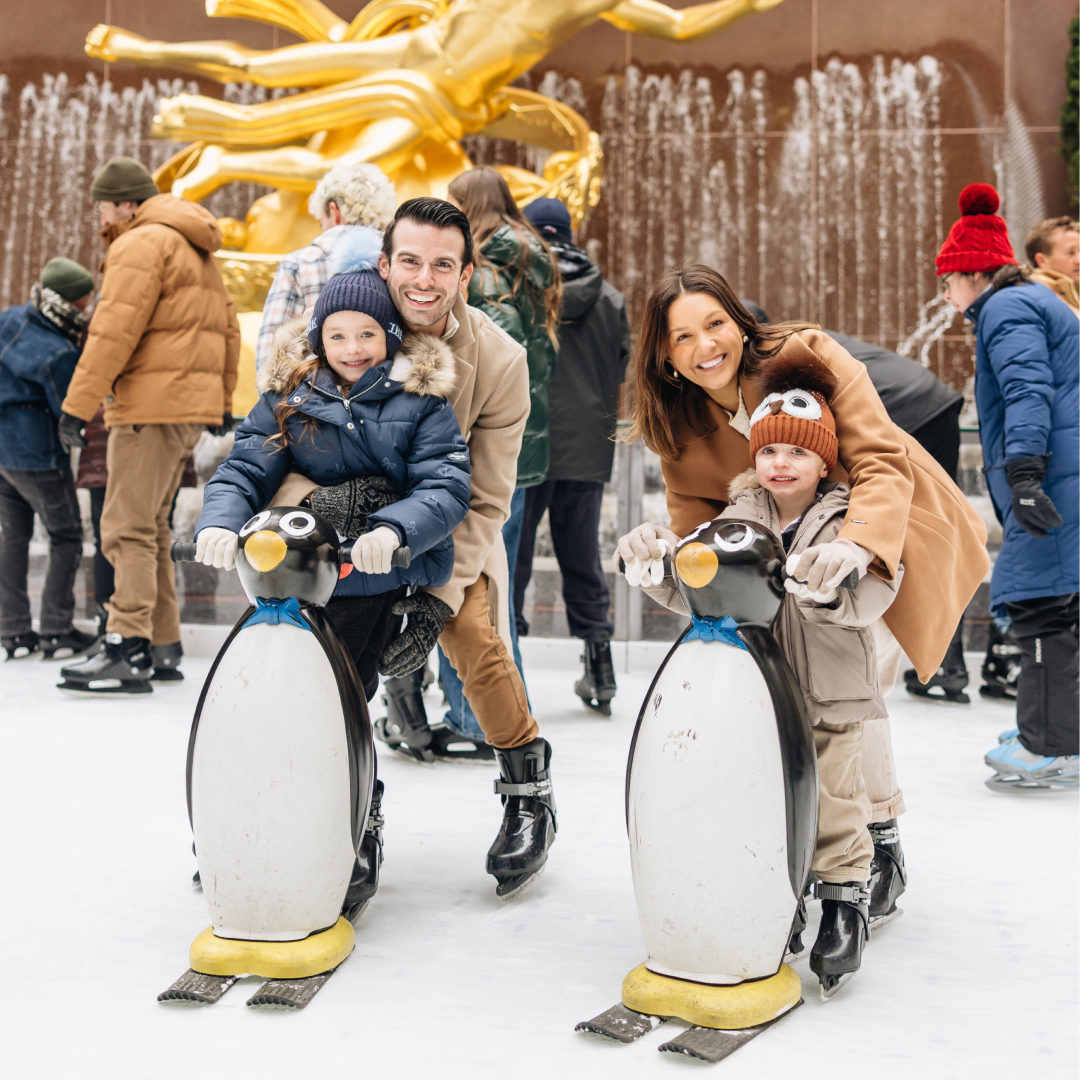 A family of four ice skating at The Rink at Rockefeller Center
