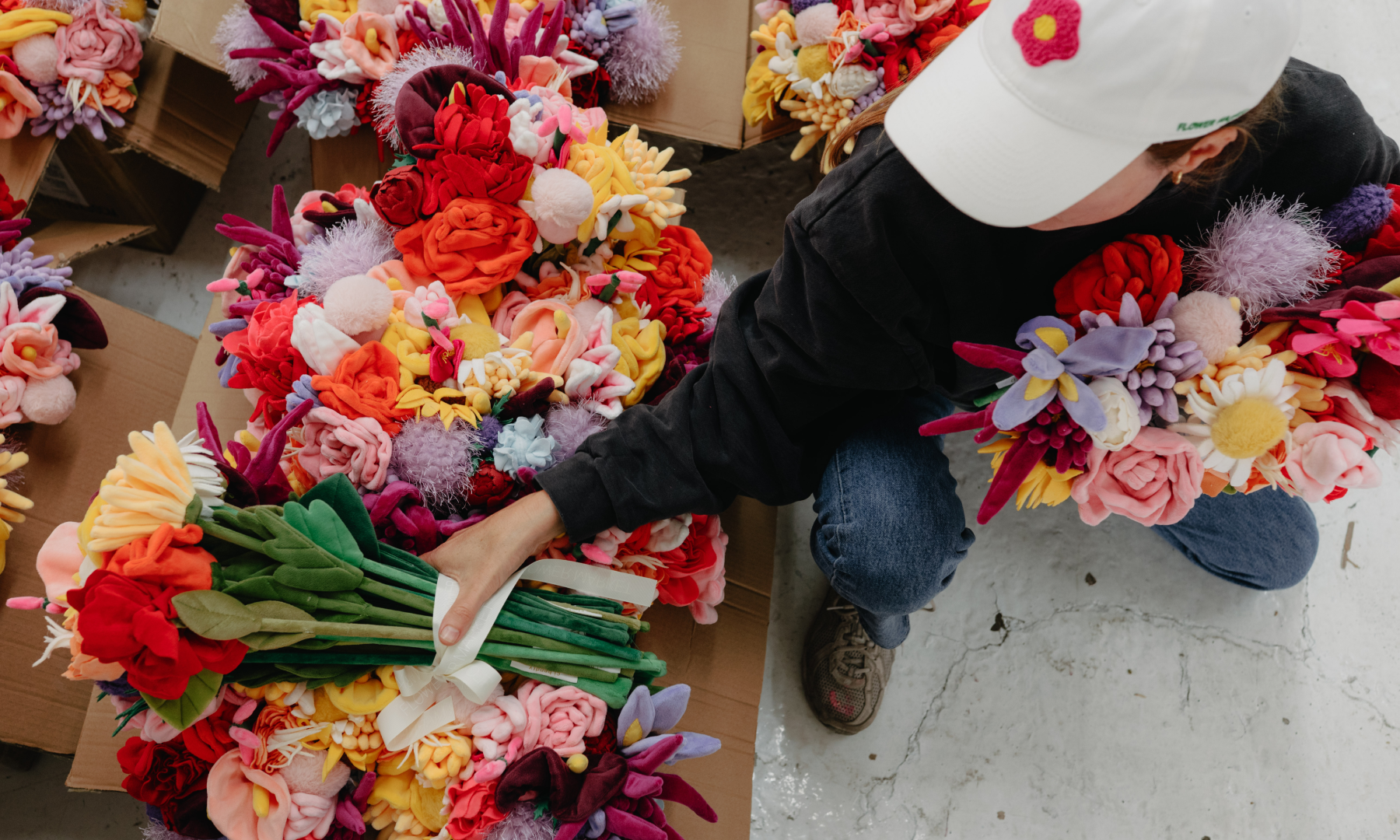 Artist Cj Hendry sorting plush flowers inside her studio