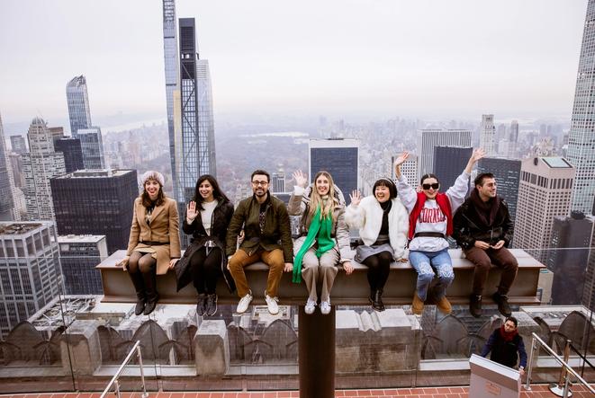 people waving and riding the beam