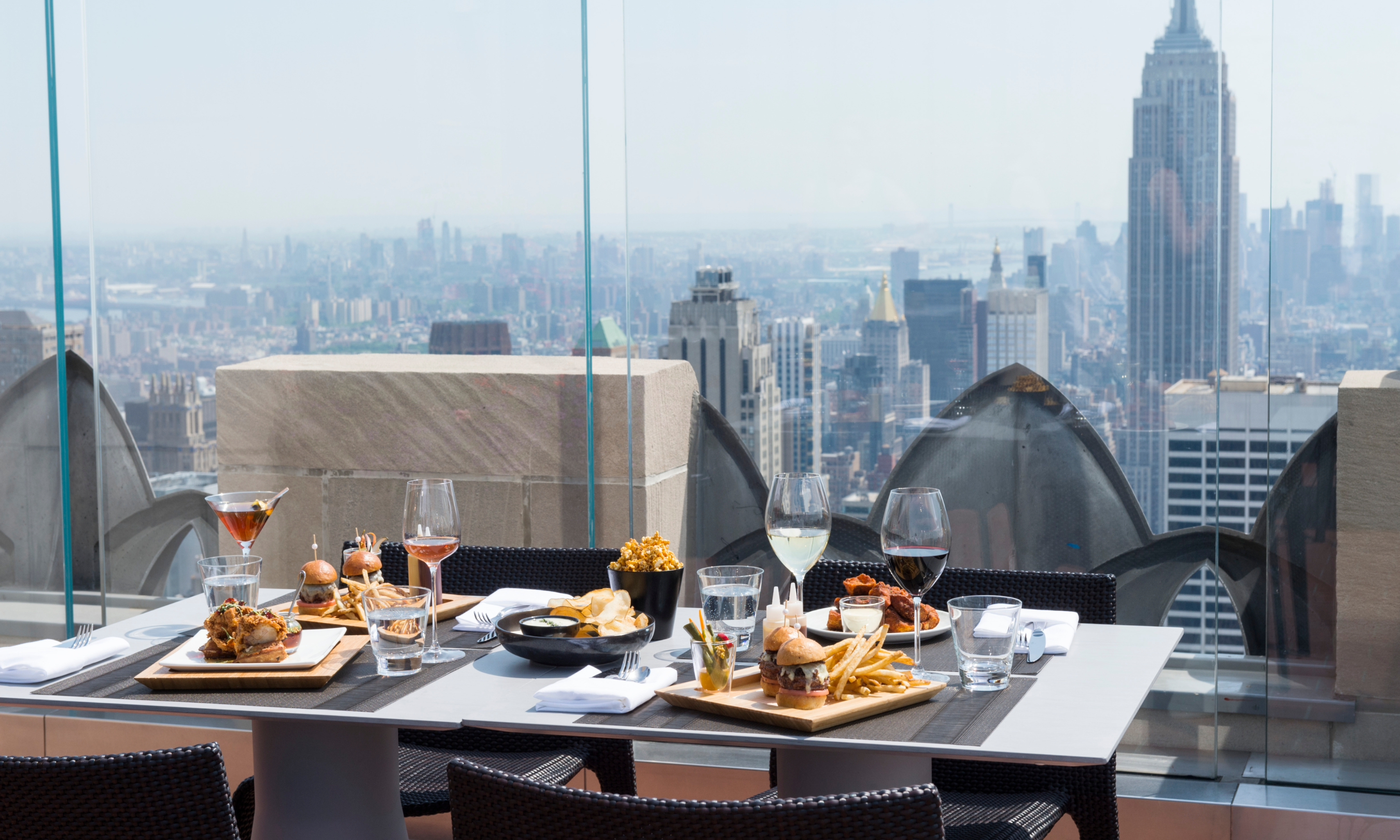 Food and drinks on a table on Bar SixtyFive's outdoor terrace