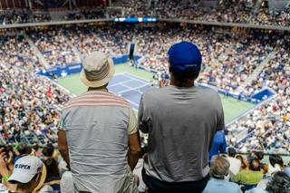 Two fans stand to cheer on tennis action during the 2022 US Open in New York City, Flushing, Queens, NY.