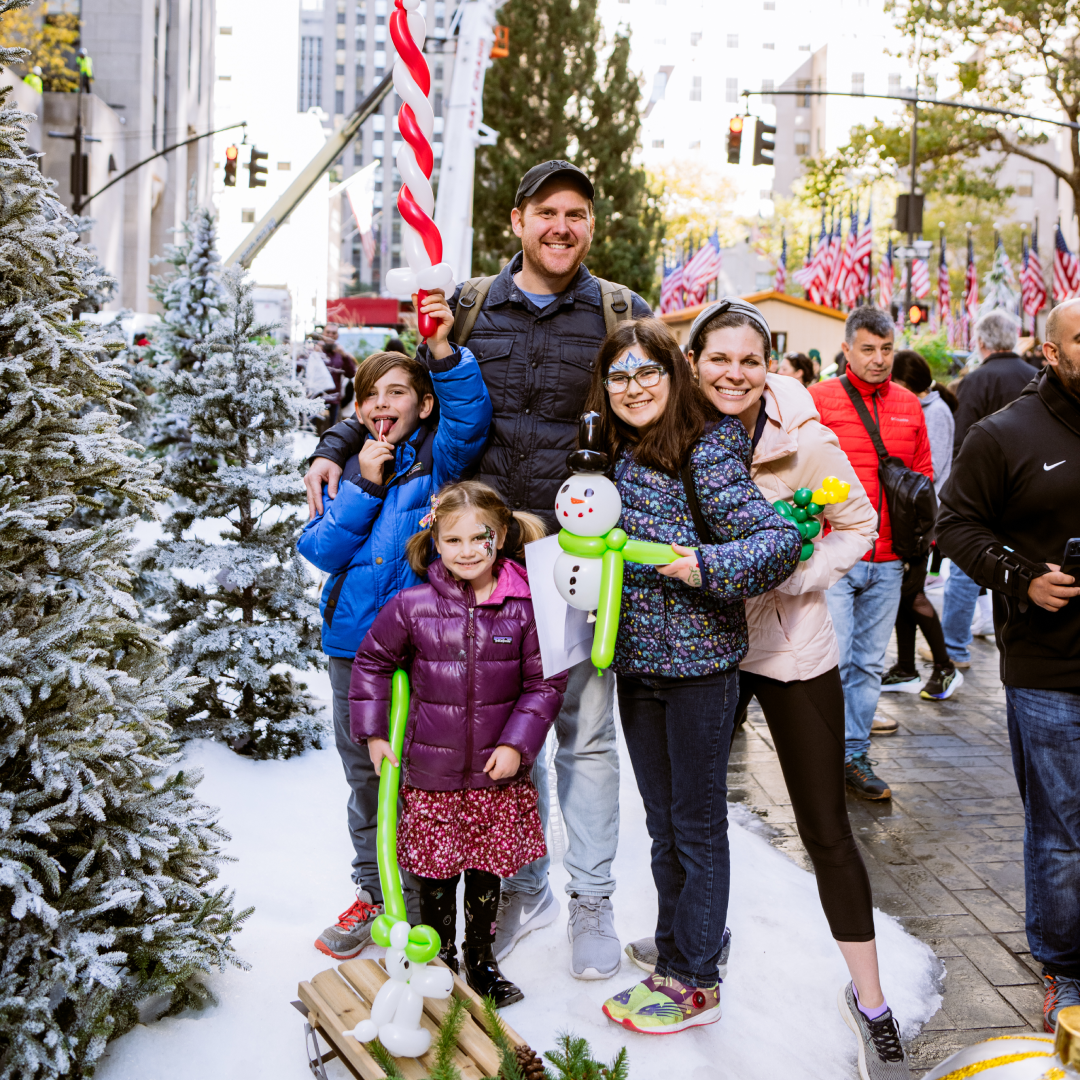 A family attending Meet the Tree Day festivities at Rockefeller Center