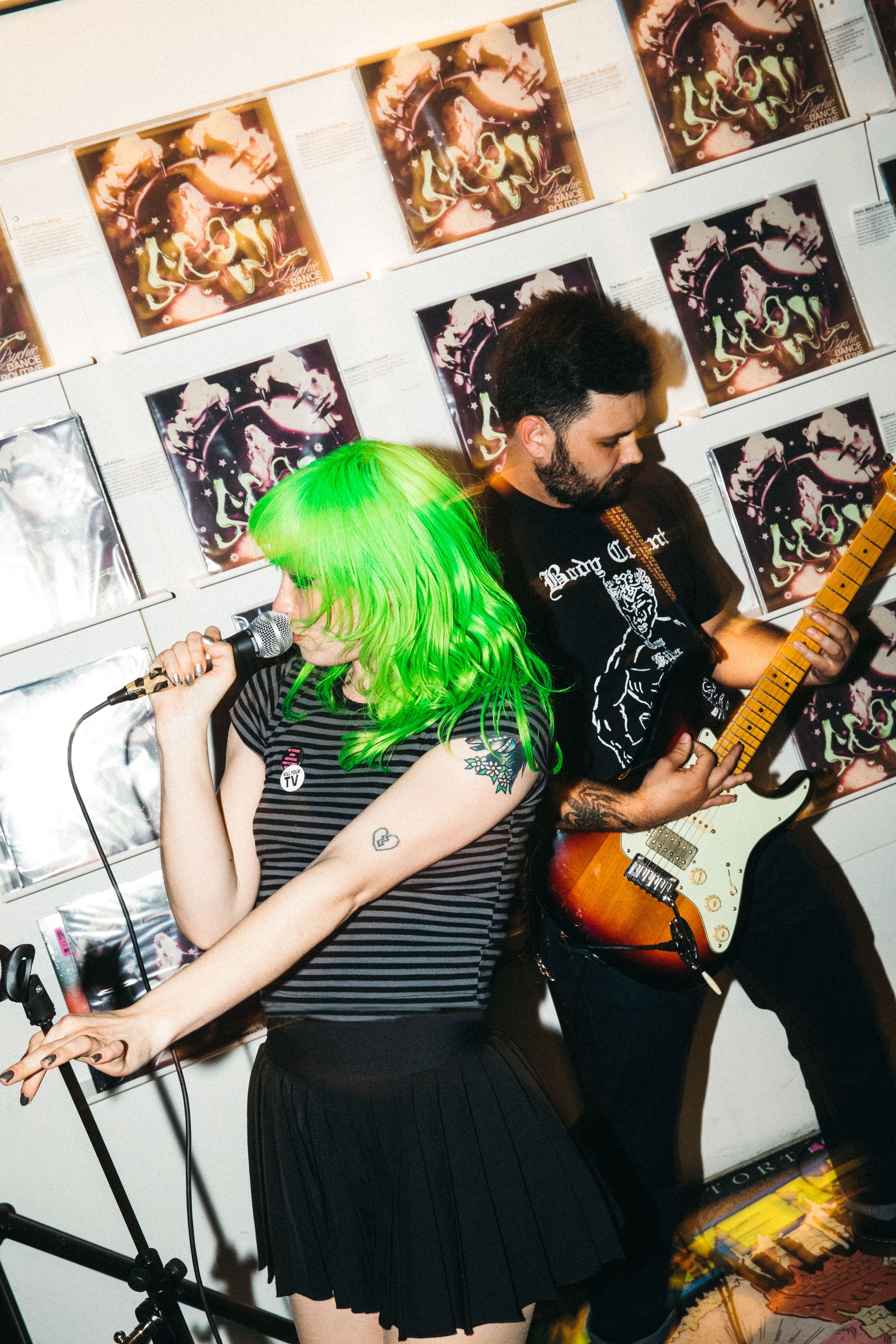 Woman singing and man playing guitar inside Rough Trade