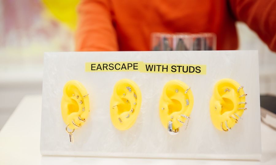Four yellow rubber ear molds with piercings to help customers plan their Earscape®