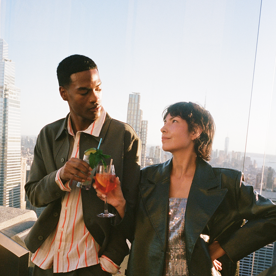 Two People Enjoying Drinks above the Skyline