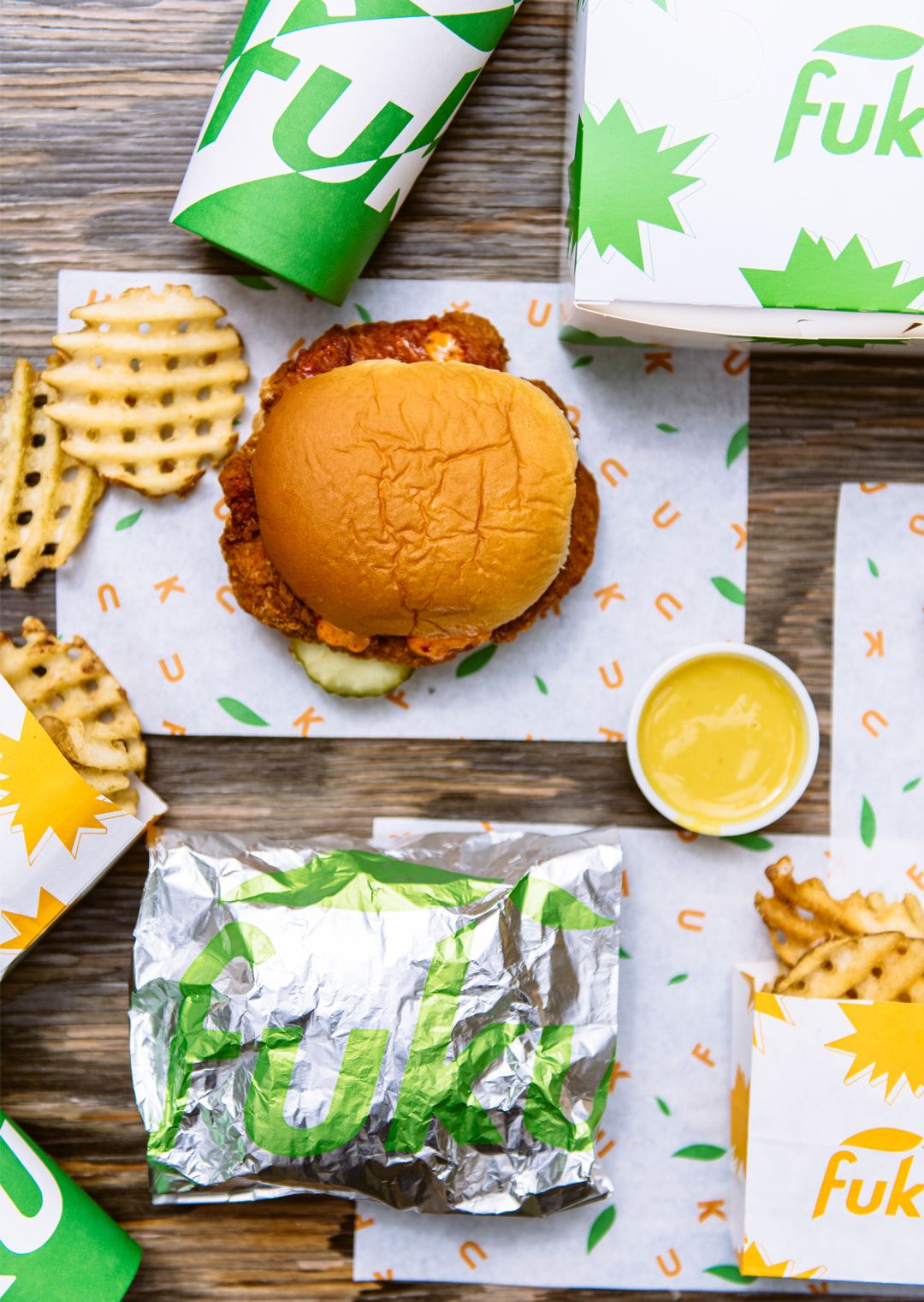 Fuku fried chicken sandwich and waffle fries on a table