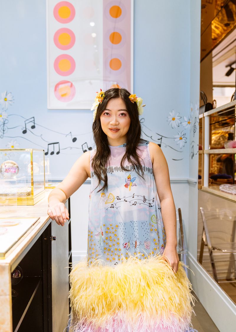 Olivia Cheng, founder of Dauphinette, surrounded by flowers.