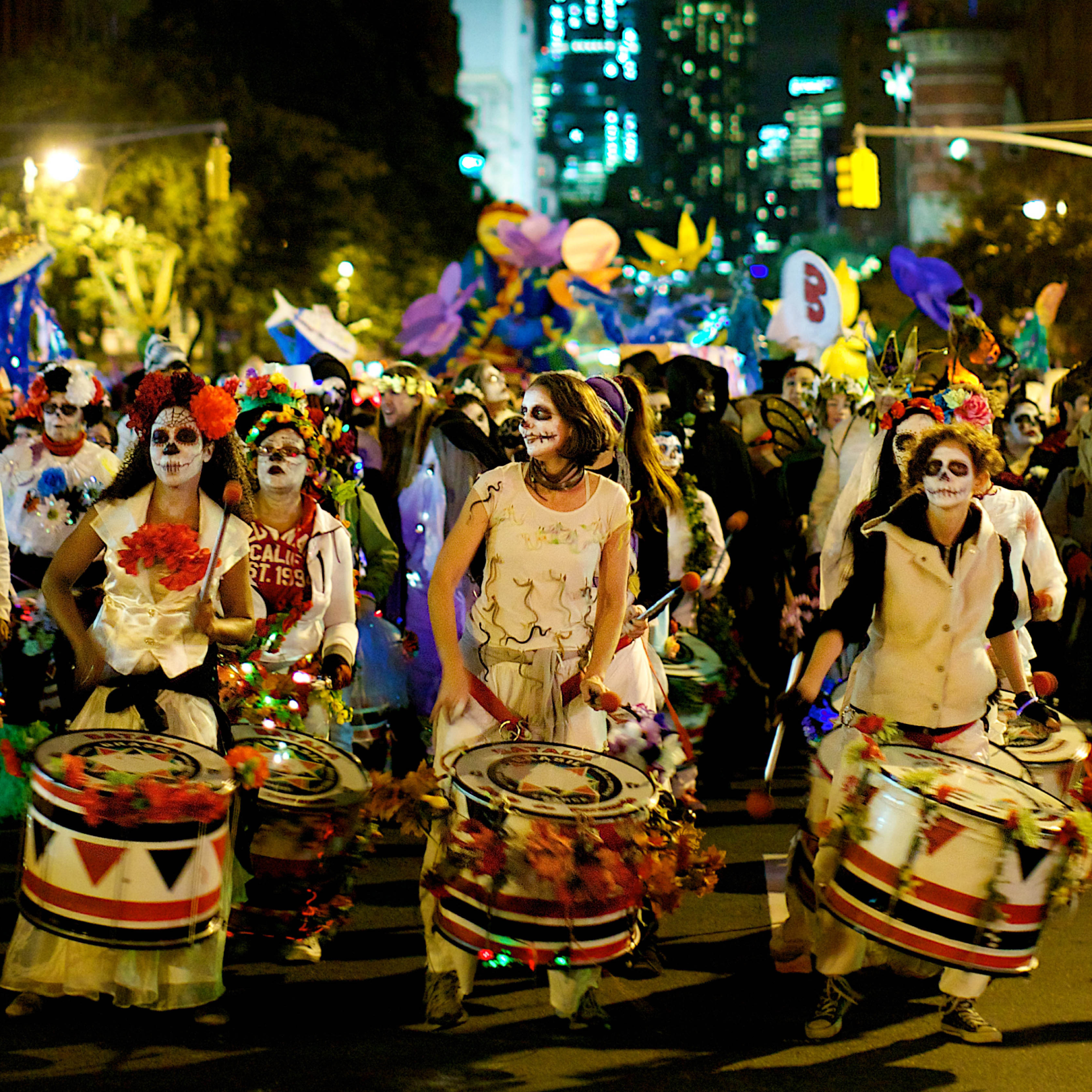 Large group of people dressed in costumes and walking in the Village Halloween Parade