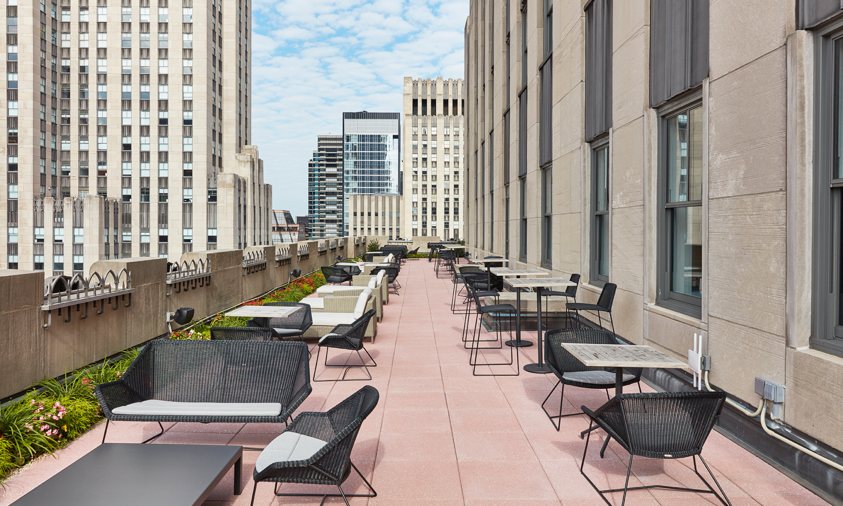 The outdoor terrace set up with tables and chairs at The Clubhouse