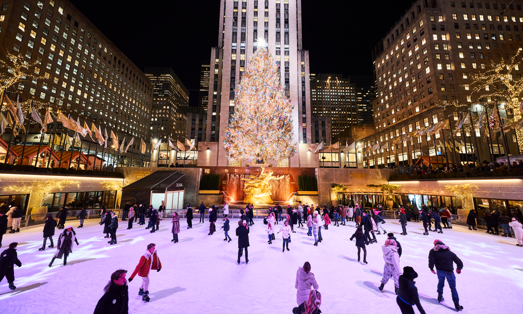 People ice skating on The Rink under the Rockefeller Center Christmas Tree