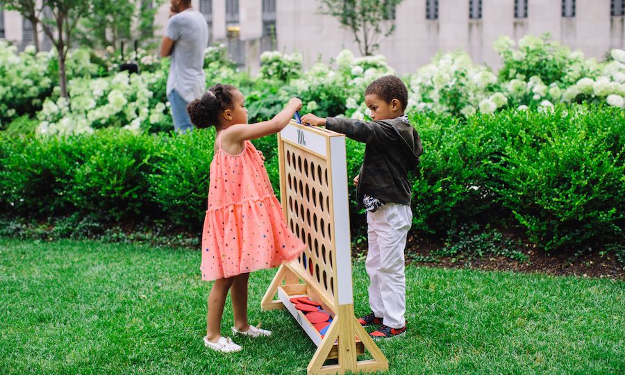 Two children playing a game of Connect Four at Radio Park