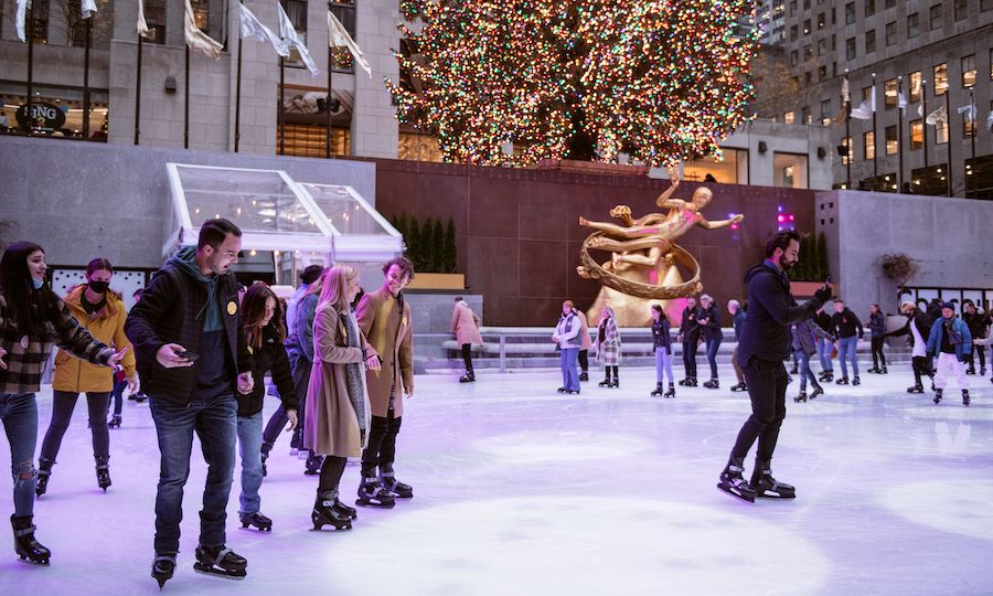 People skating at The Rink at night