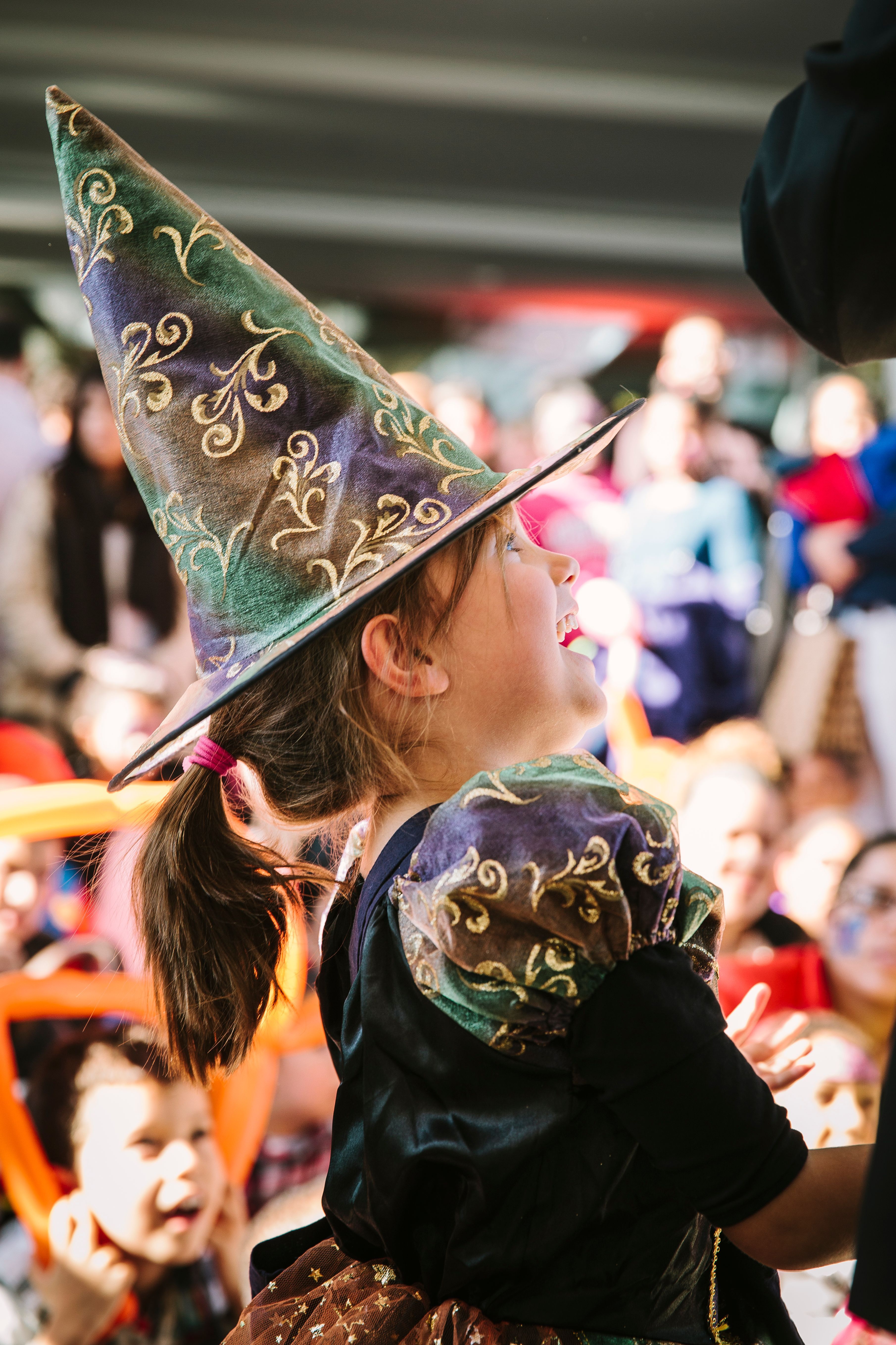 a little girl in a witch costume