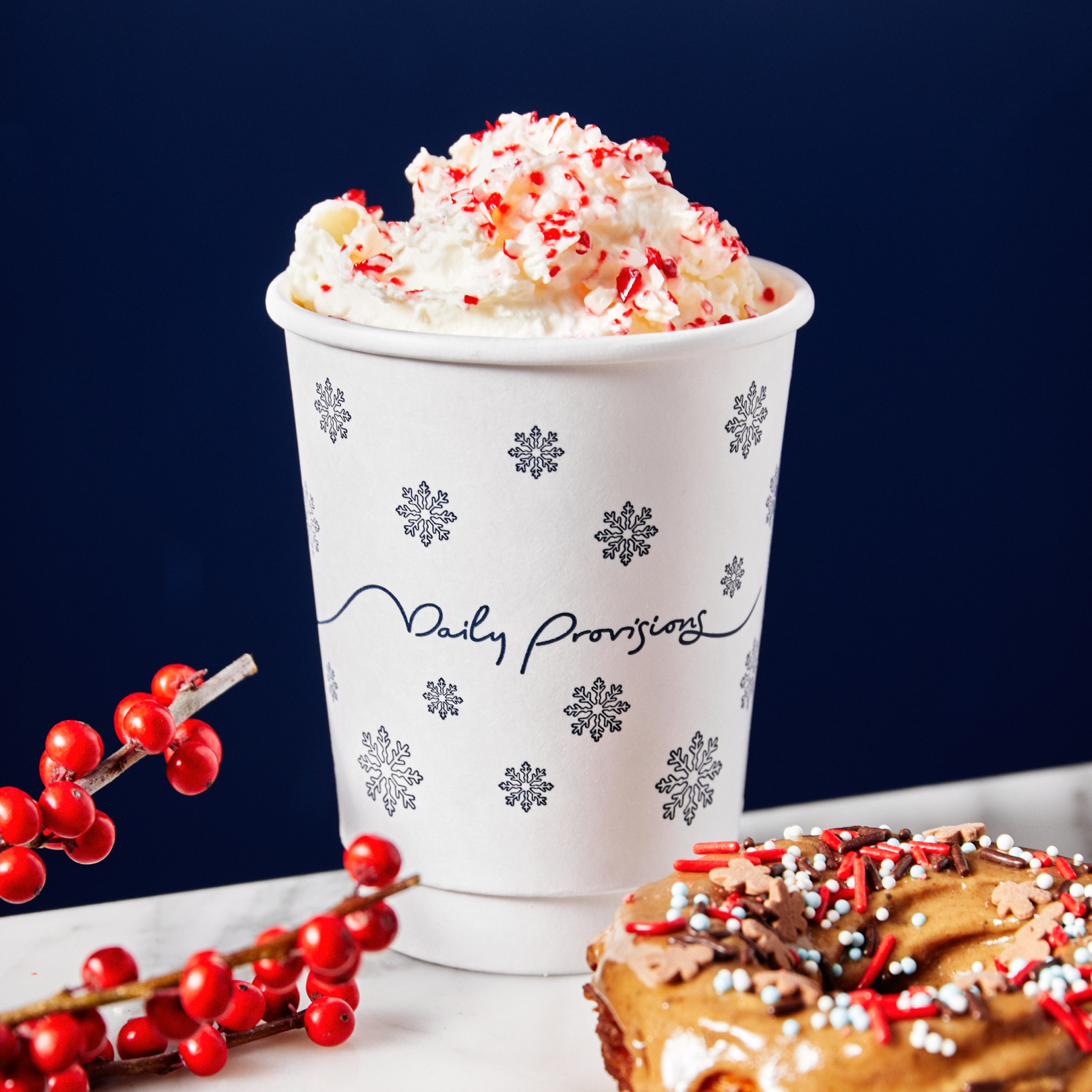 A cup of Candy Cane Cocoa and a donut from Daily Provisions at Rockefeller Center