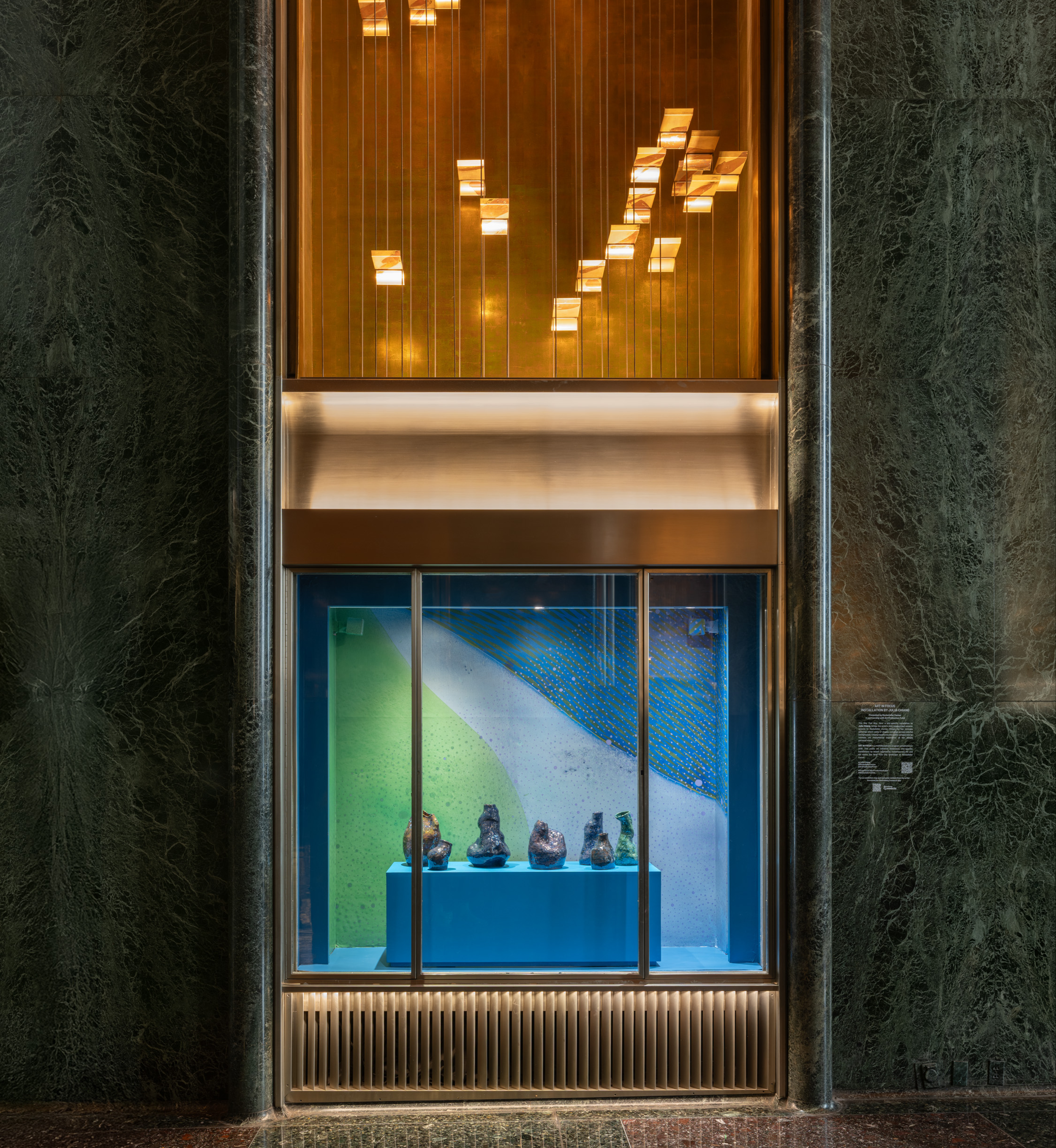 Artist Julia Chiang's ceramic sculptures inside a vitrine at Rockefeller Center