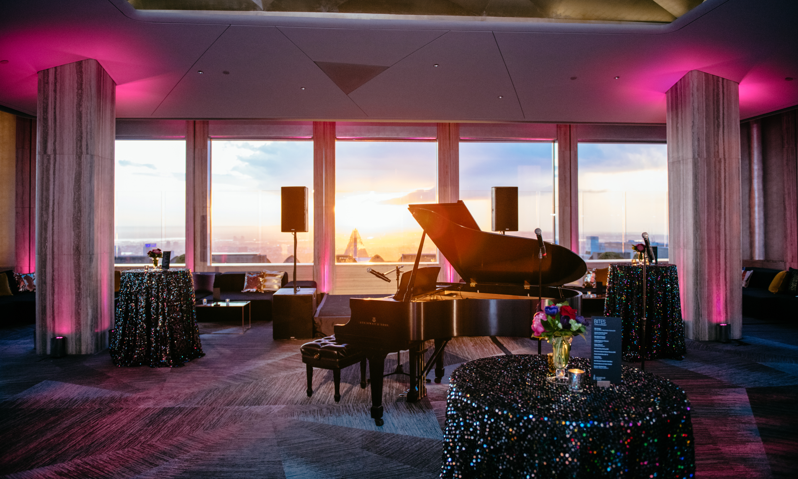 Bar tables and a grand piano inside the bar area at Rainbow Room