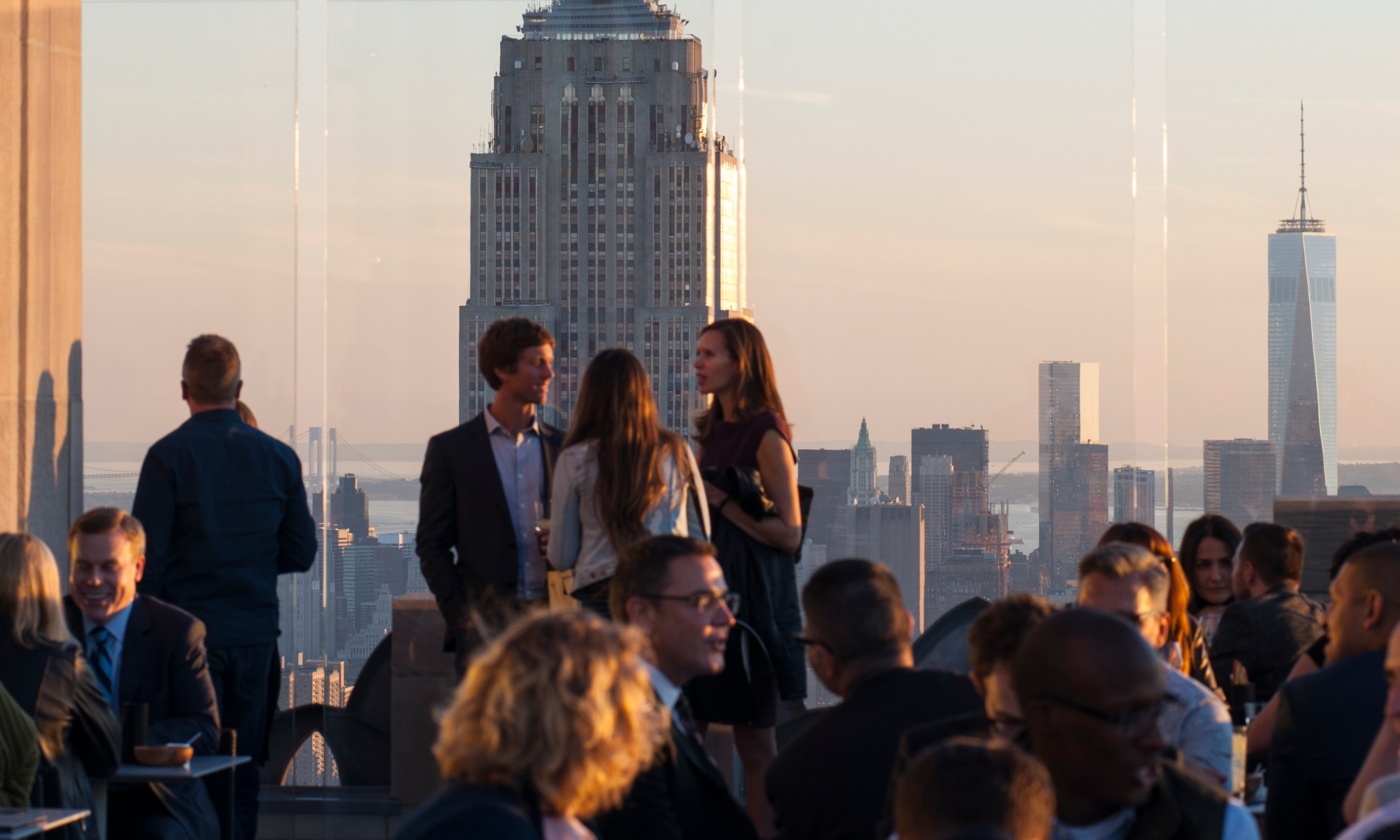 Large group of people gathered on Bar SixtyFive's outdoor terrace