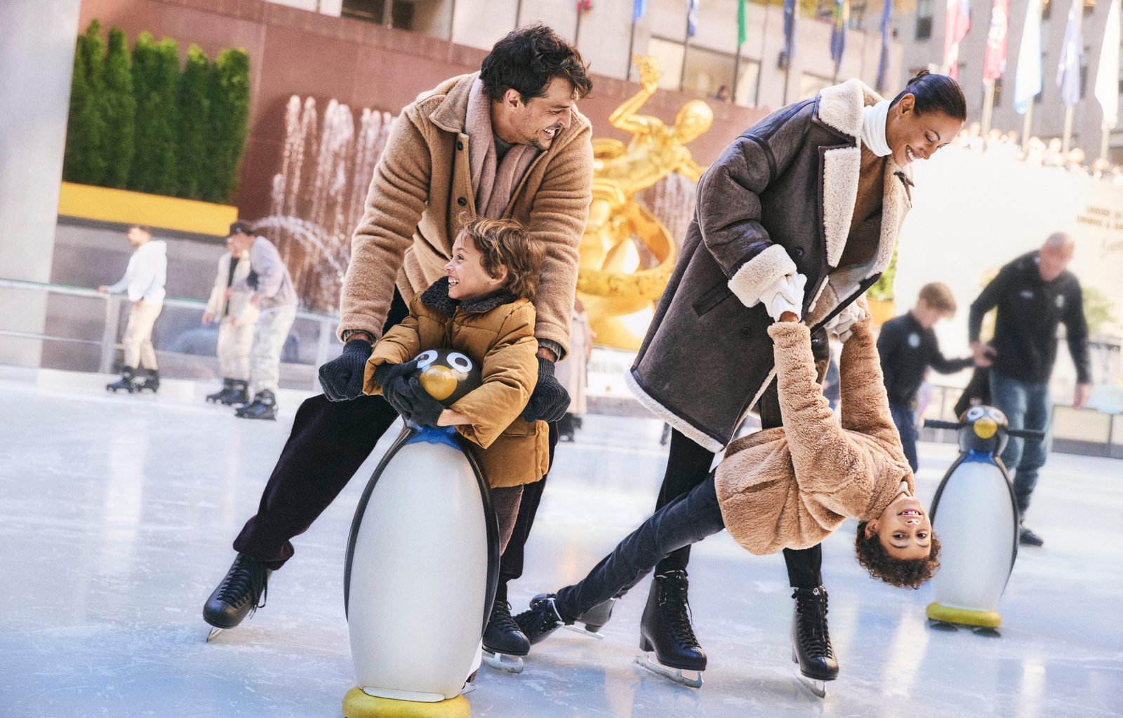 a family skating on the ice rink