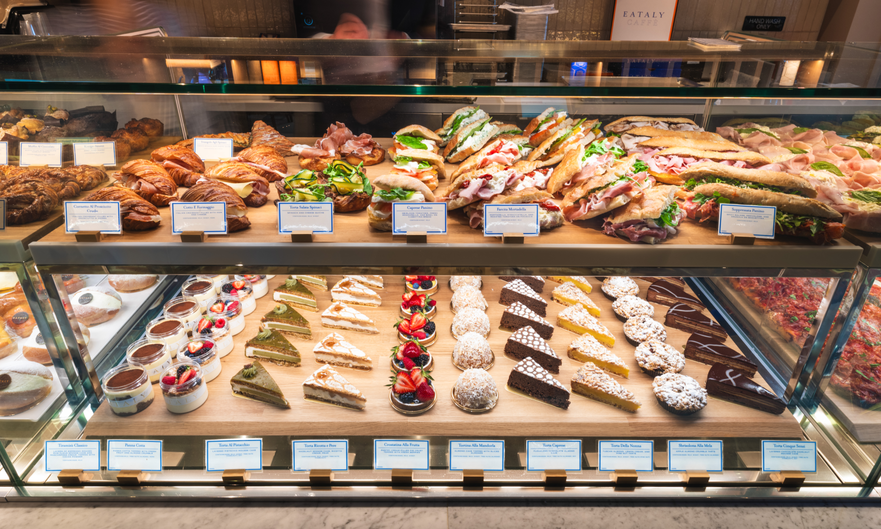 Assorted sandwiches and pastries on display at Eataly Caffè