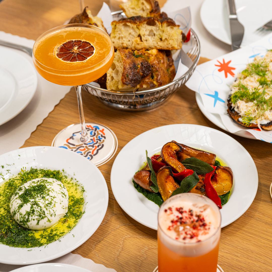 Various plates and drinks on a table at Jupiter at Rockefeller Center