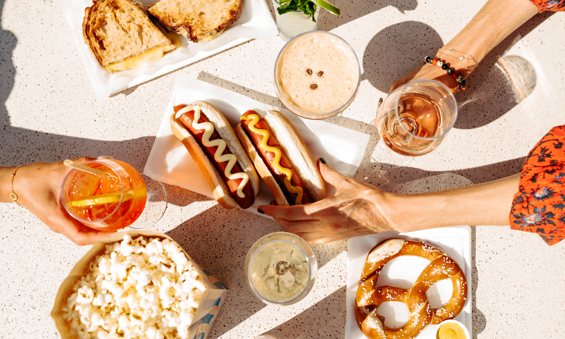 Various plates of food and drinks from The Weather Room's rooftop bar