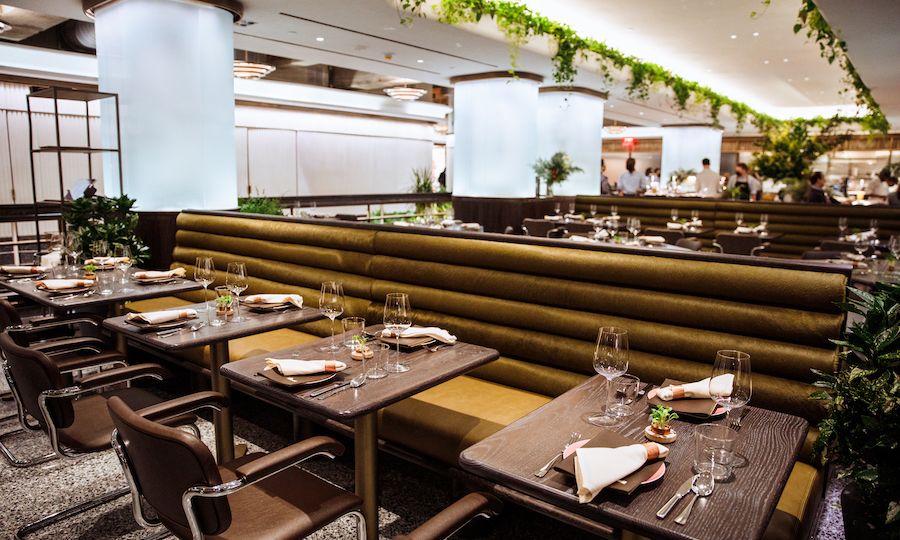 Tables, chairs, and booth seating at 5 Acres