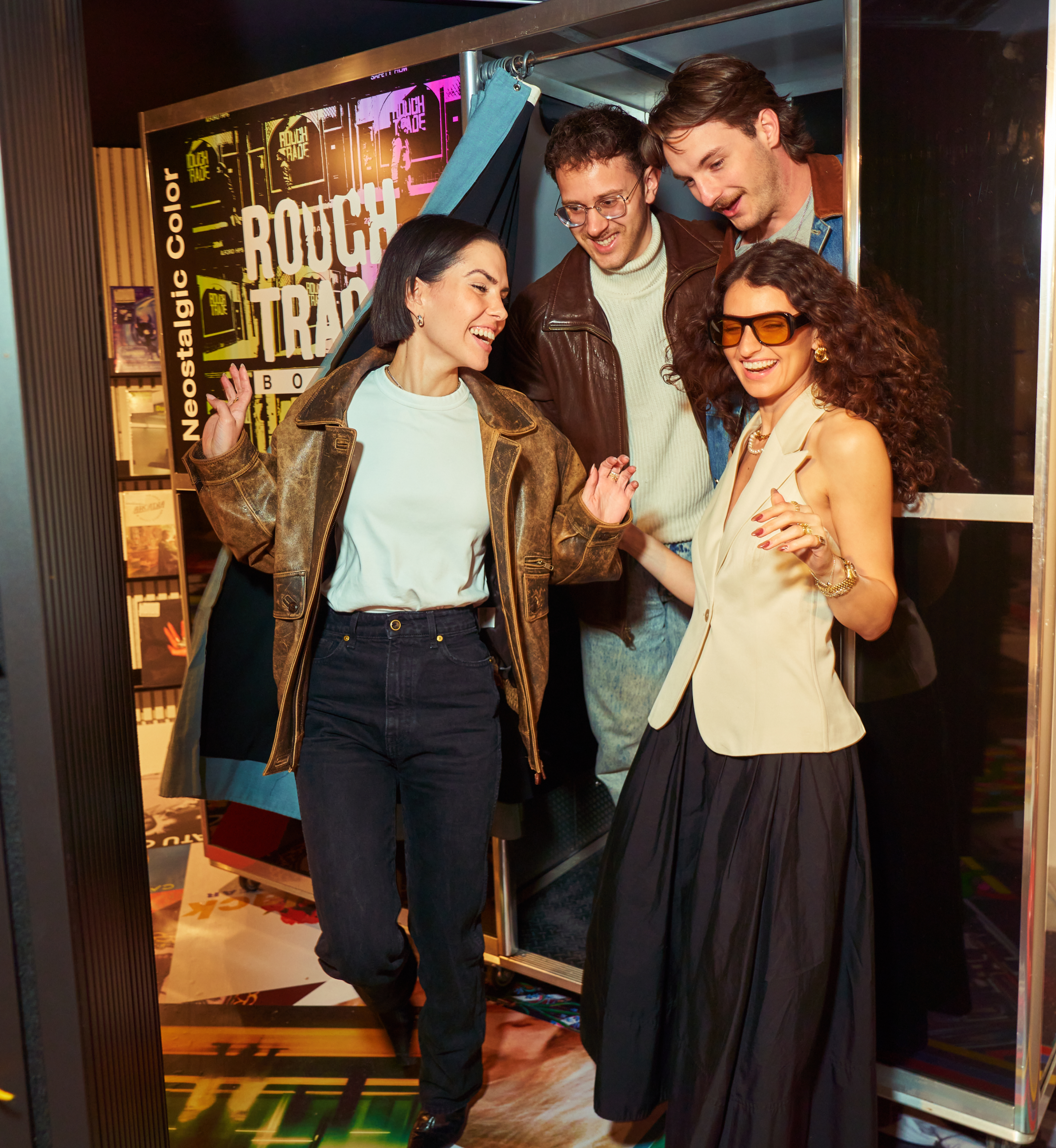 Four people inside the photo booth at Rough Trade Below
