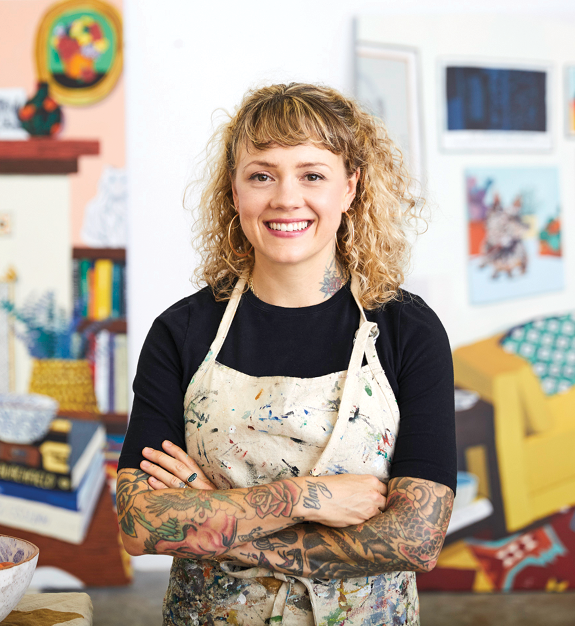 Artist Hilary Pecis posing in her studio