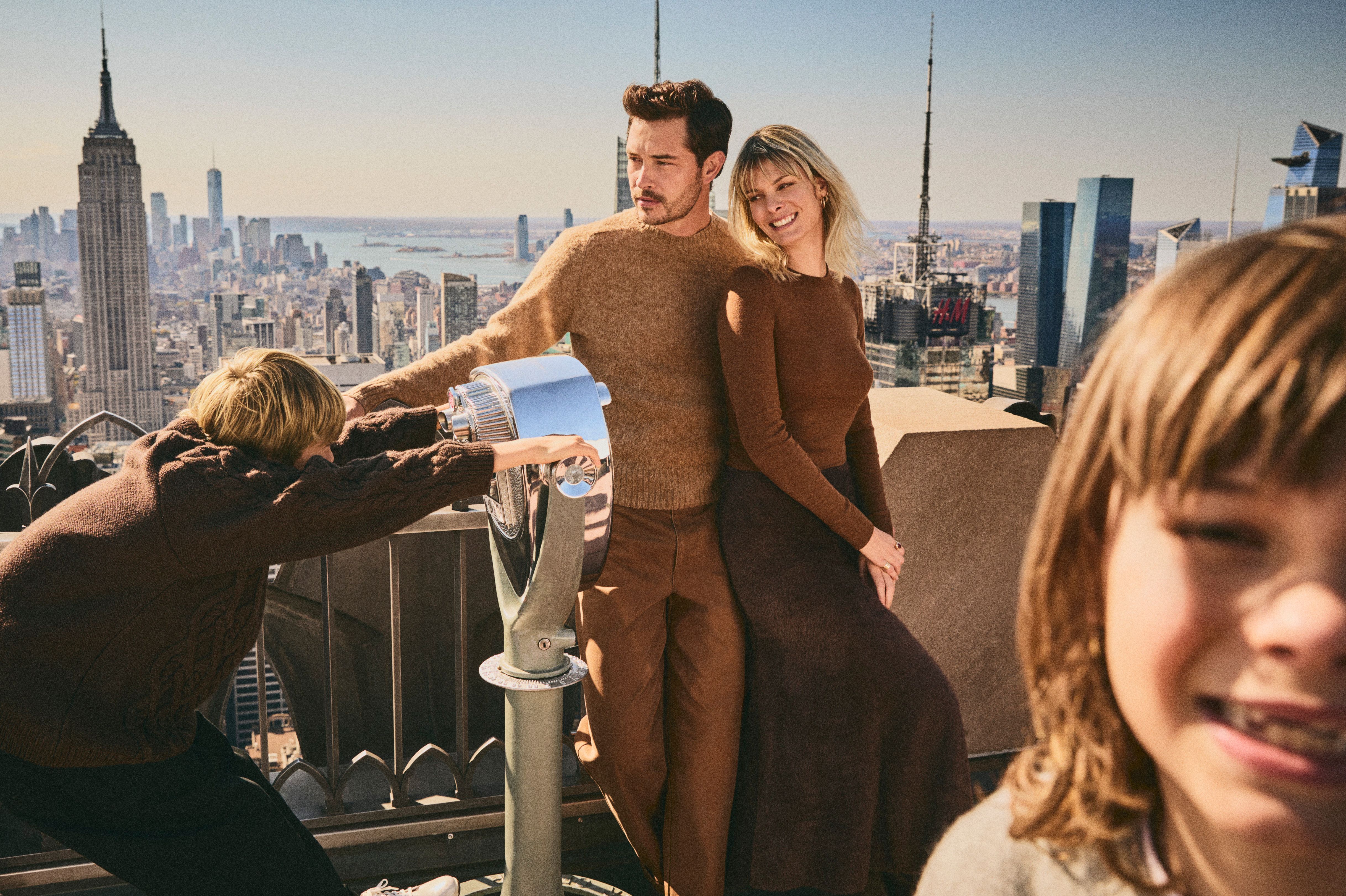 family smiling at top of the rock