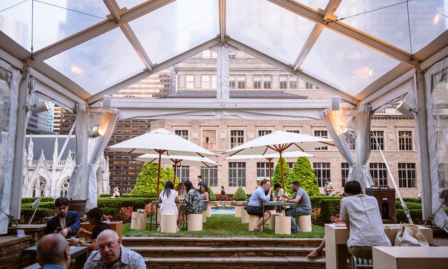 People sitting under a clear tent at 620 Loft & Garden