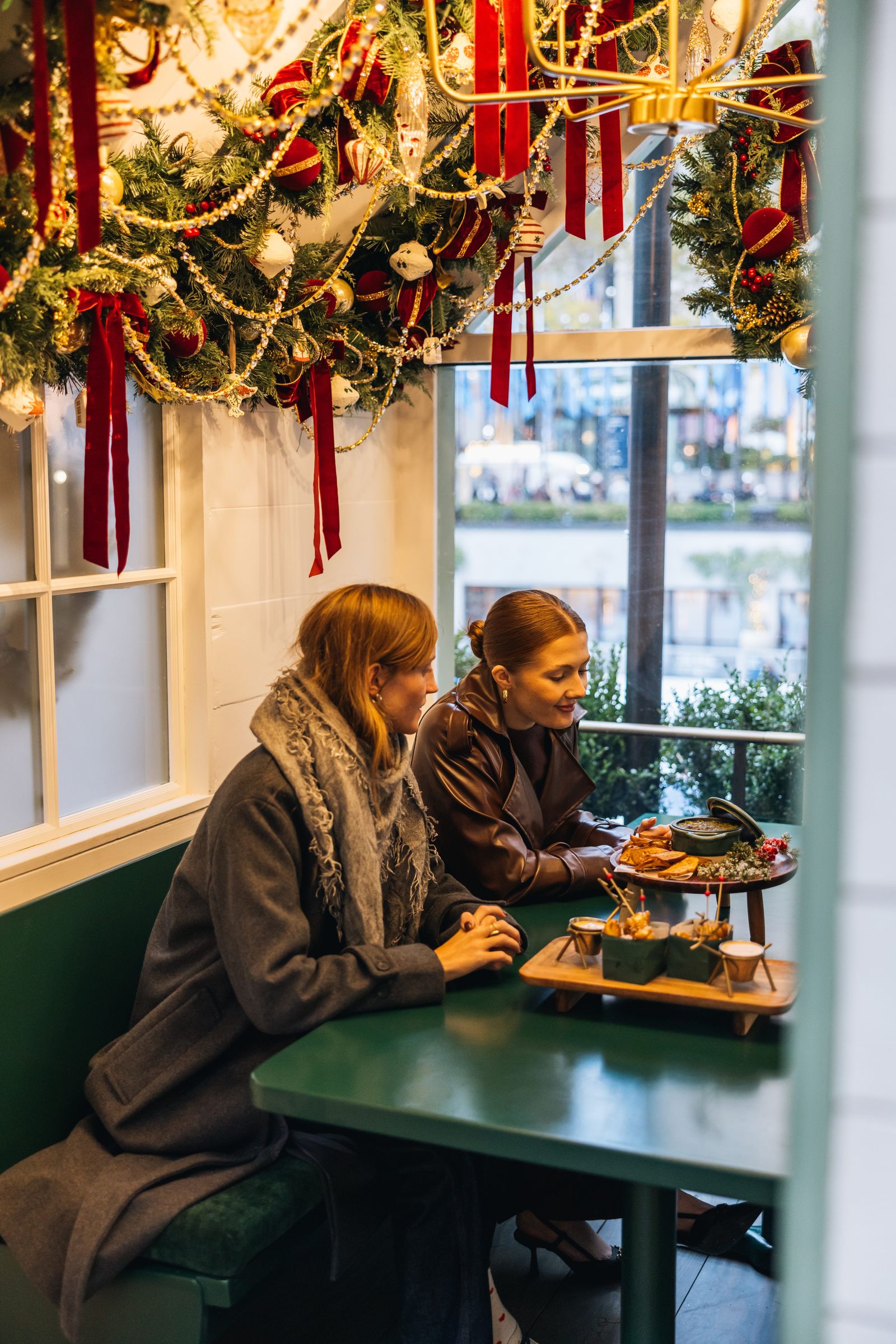 Friends seated in an Apres Skate Chalet at the Rink at Rockefeller Center