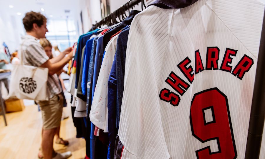 Two people looking at soccer jerseys at Saturdays Football at Rockefeller Center