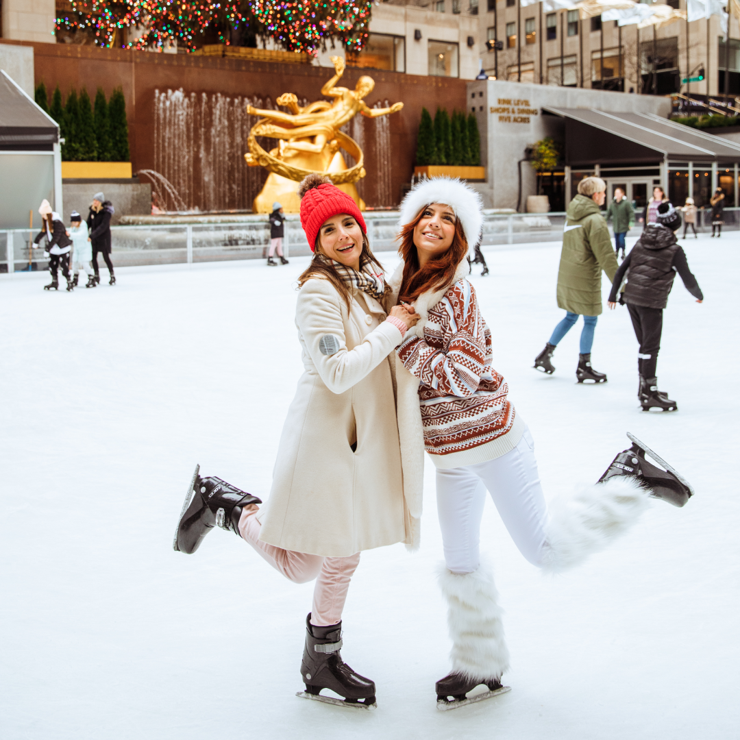Two women posing for a photo at The Rink at Rockefeller Center