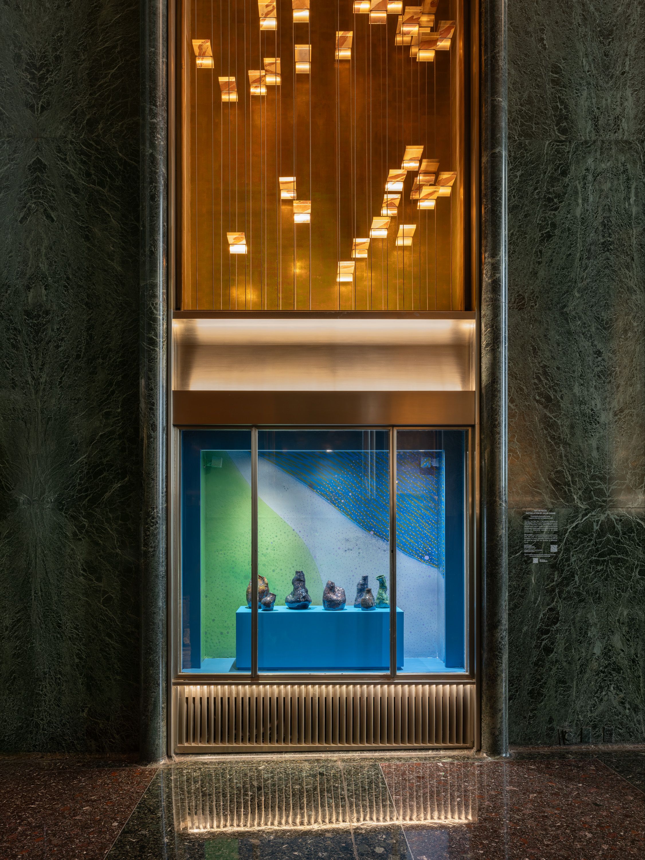 Vitrine with 5 vases on a blue base