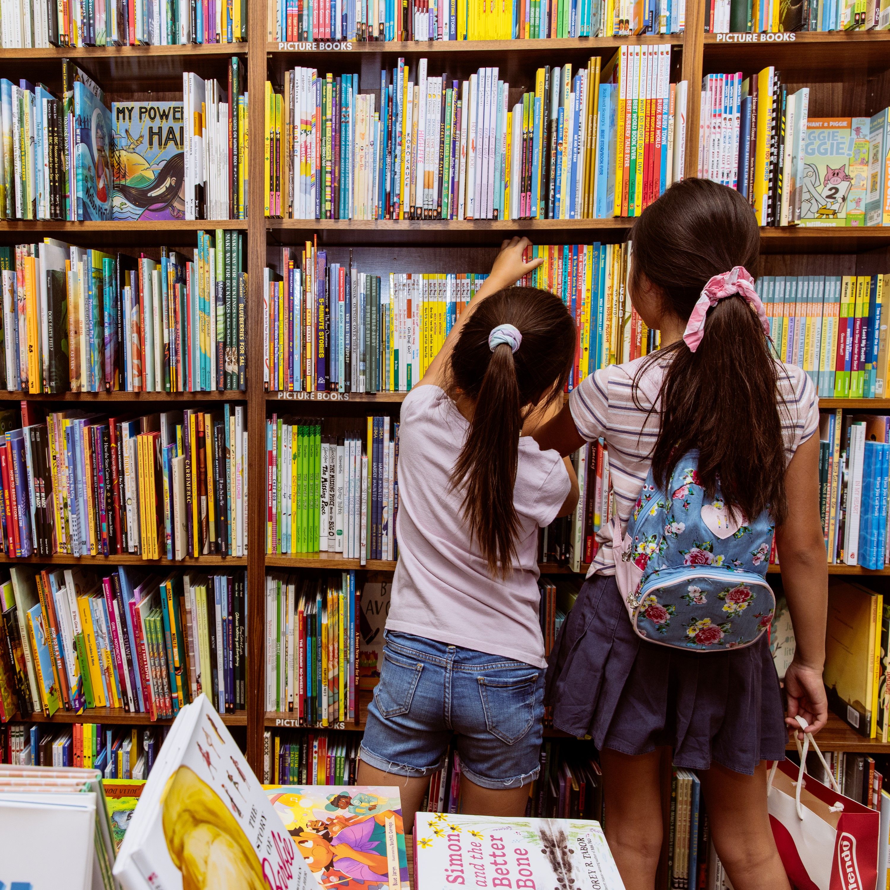 Two girls looking for books at McNally Jackson bookstore at Rockefeller Center