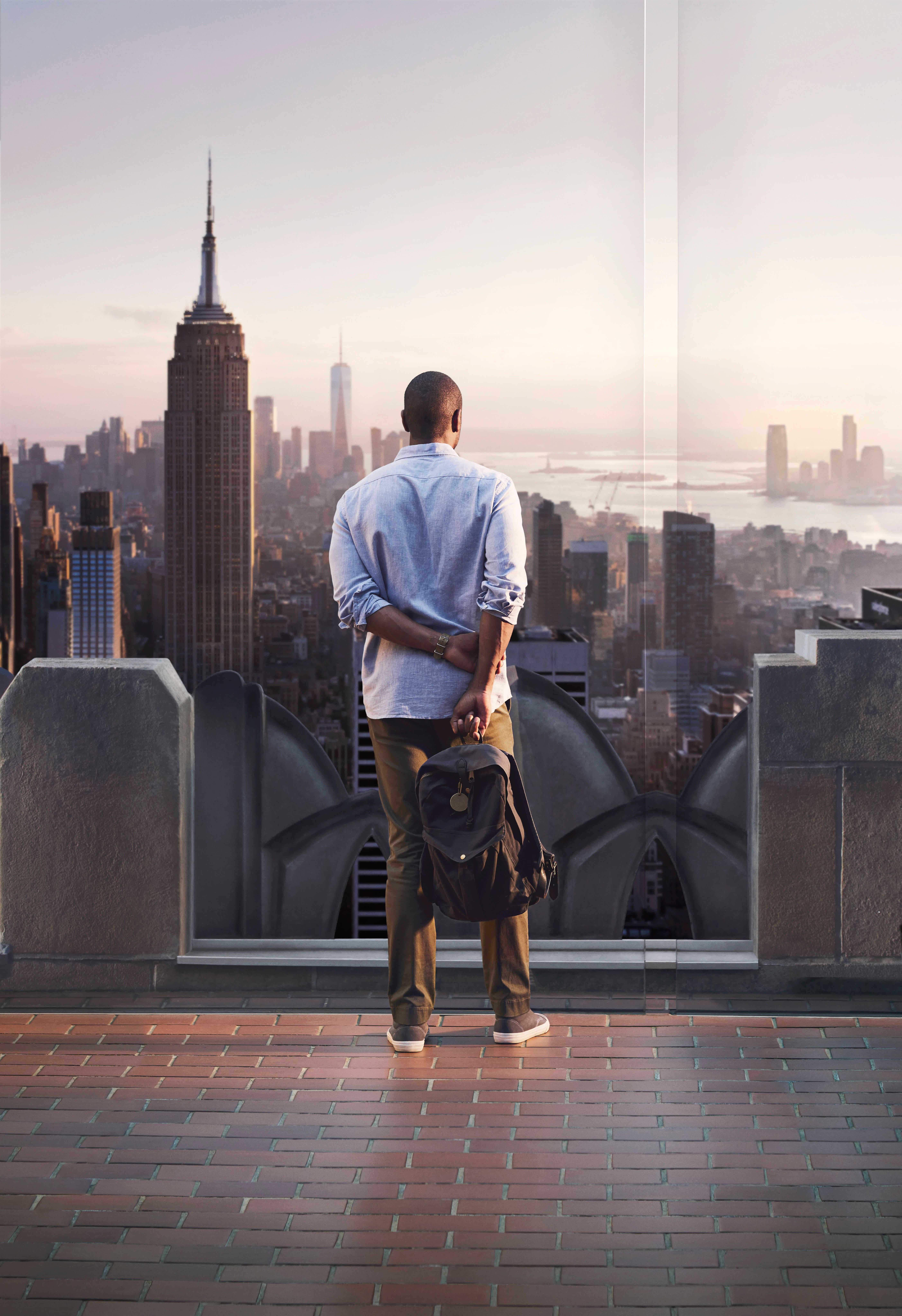 Man looks at the view at the Top of the Rock