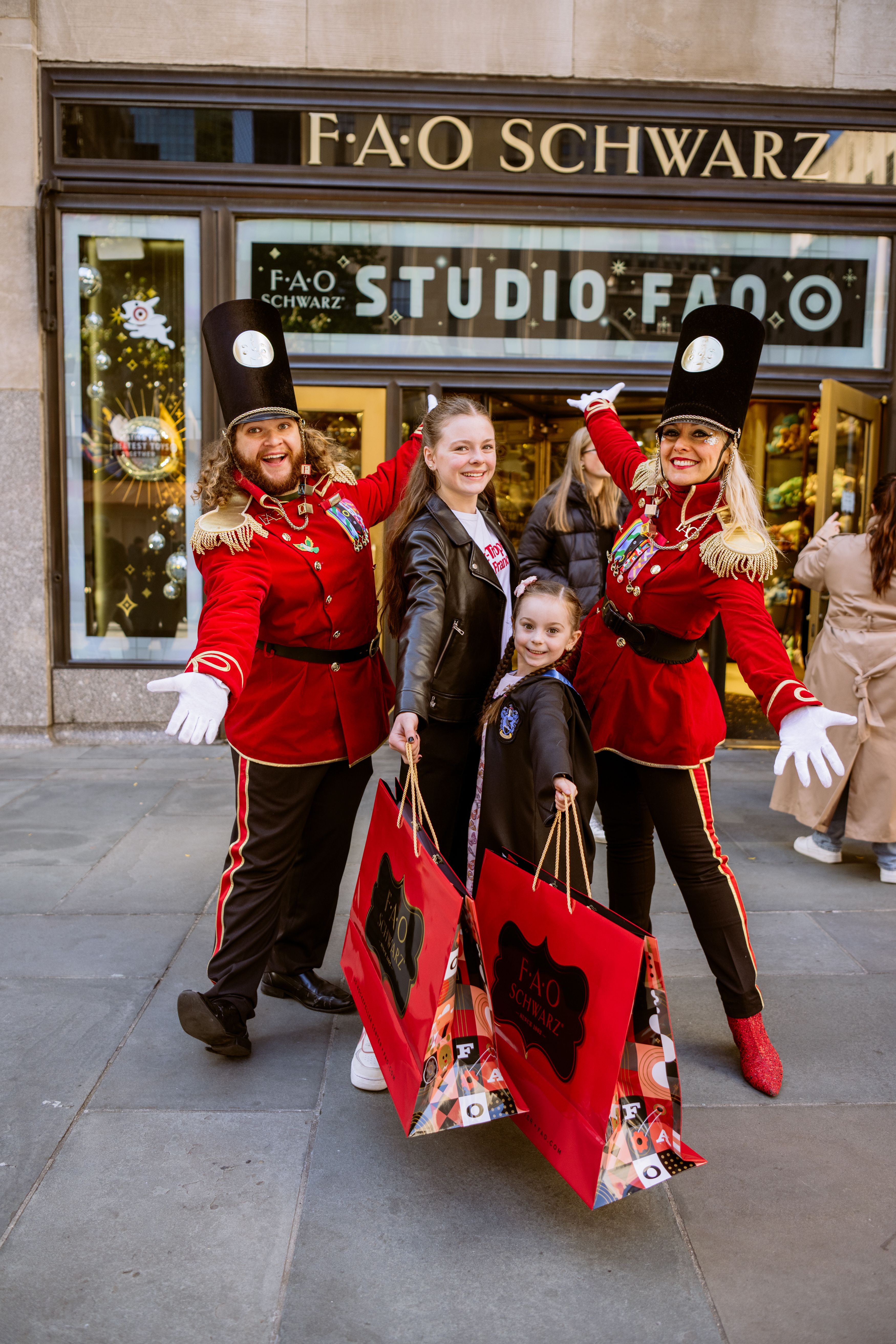 4 people posed outside FAO Schwarz