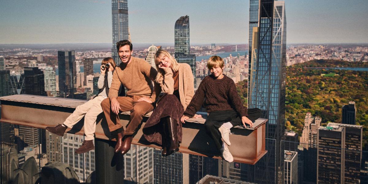 A family sits atop the Beam at Rockefeller Center