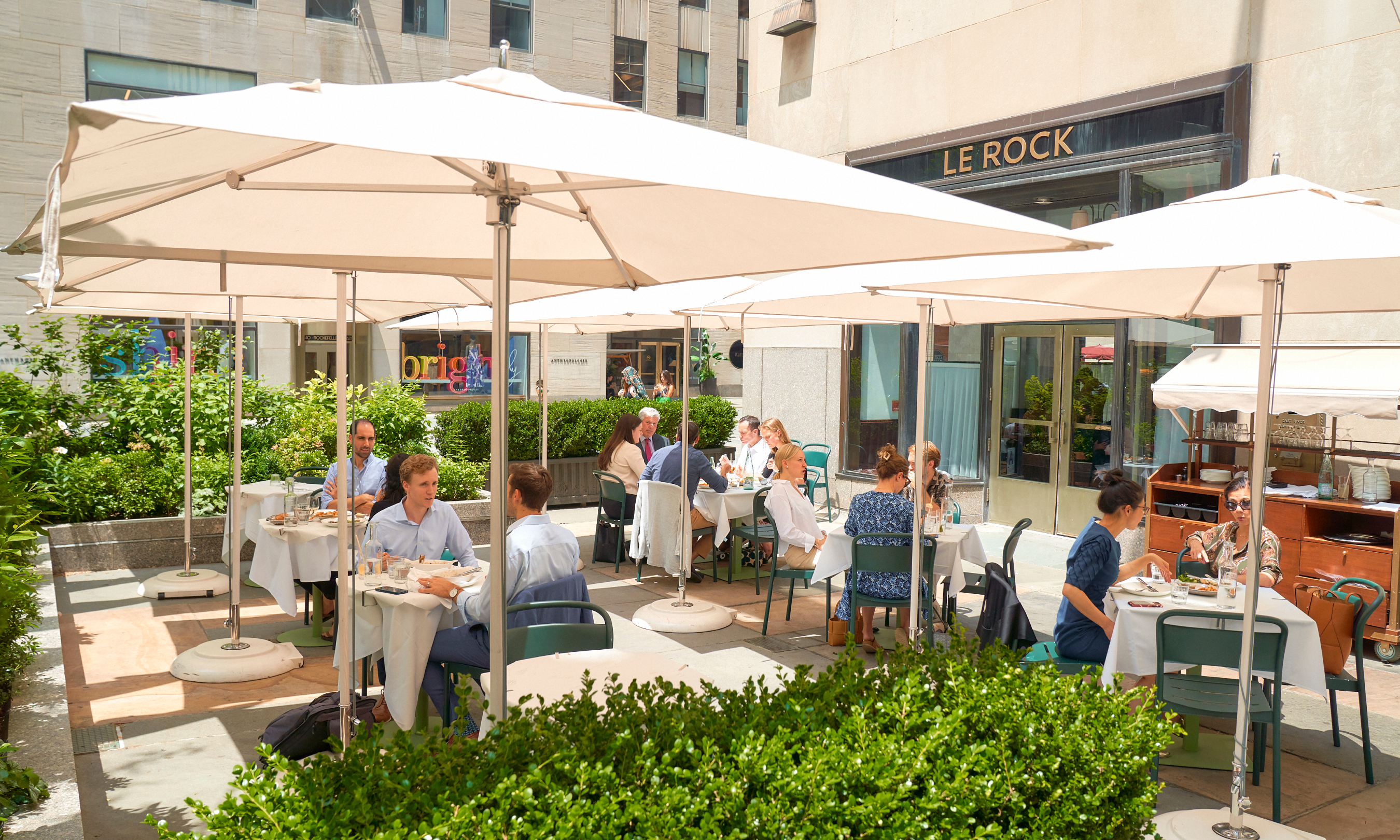 People sitting at tables on Le Rock's outdoor patio
