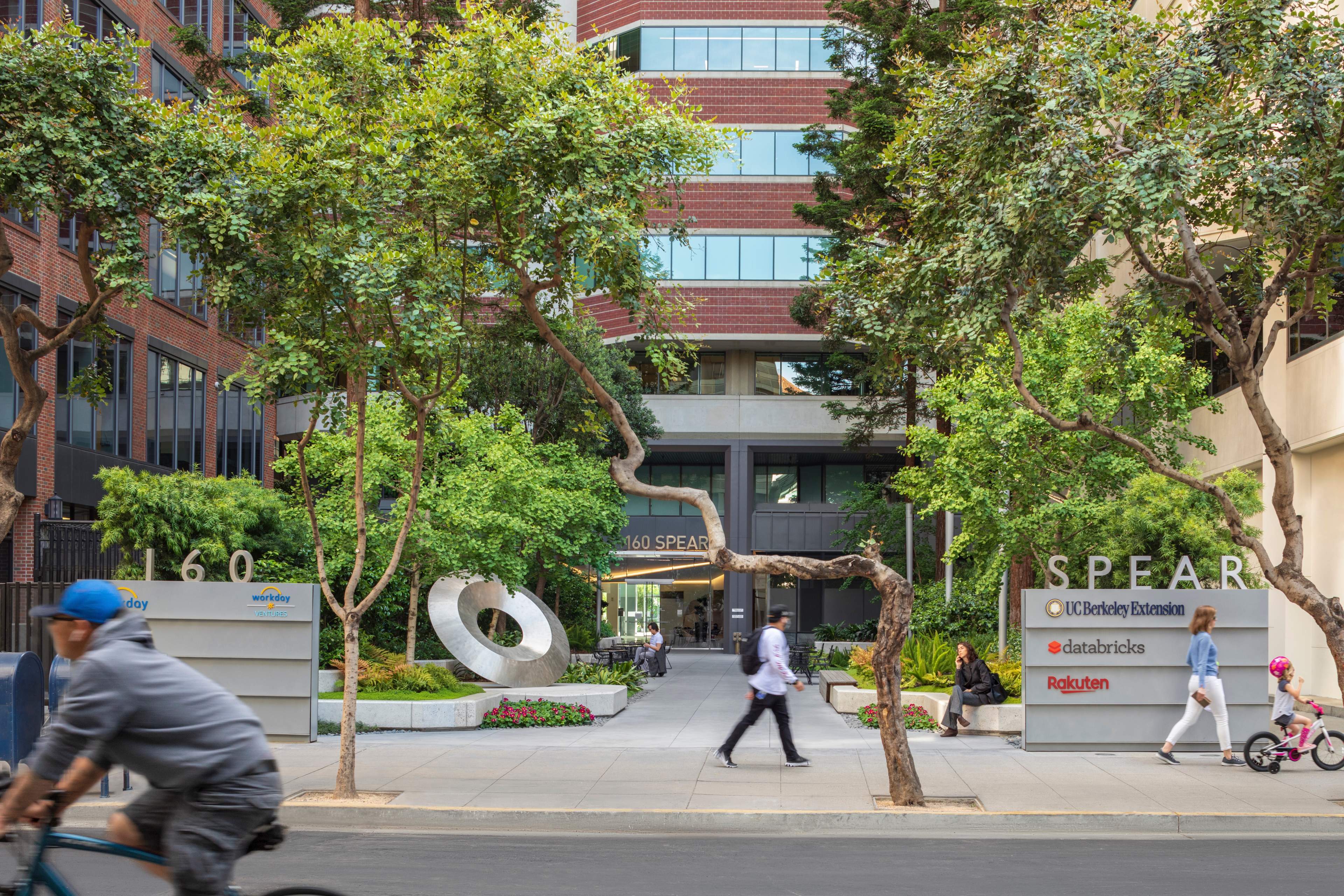 Exterior view of 160 Spear with trees and people in front