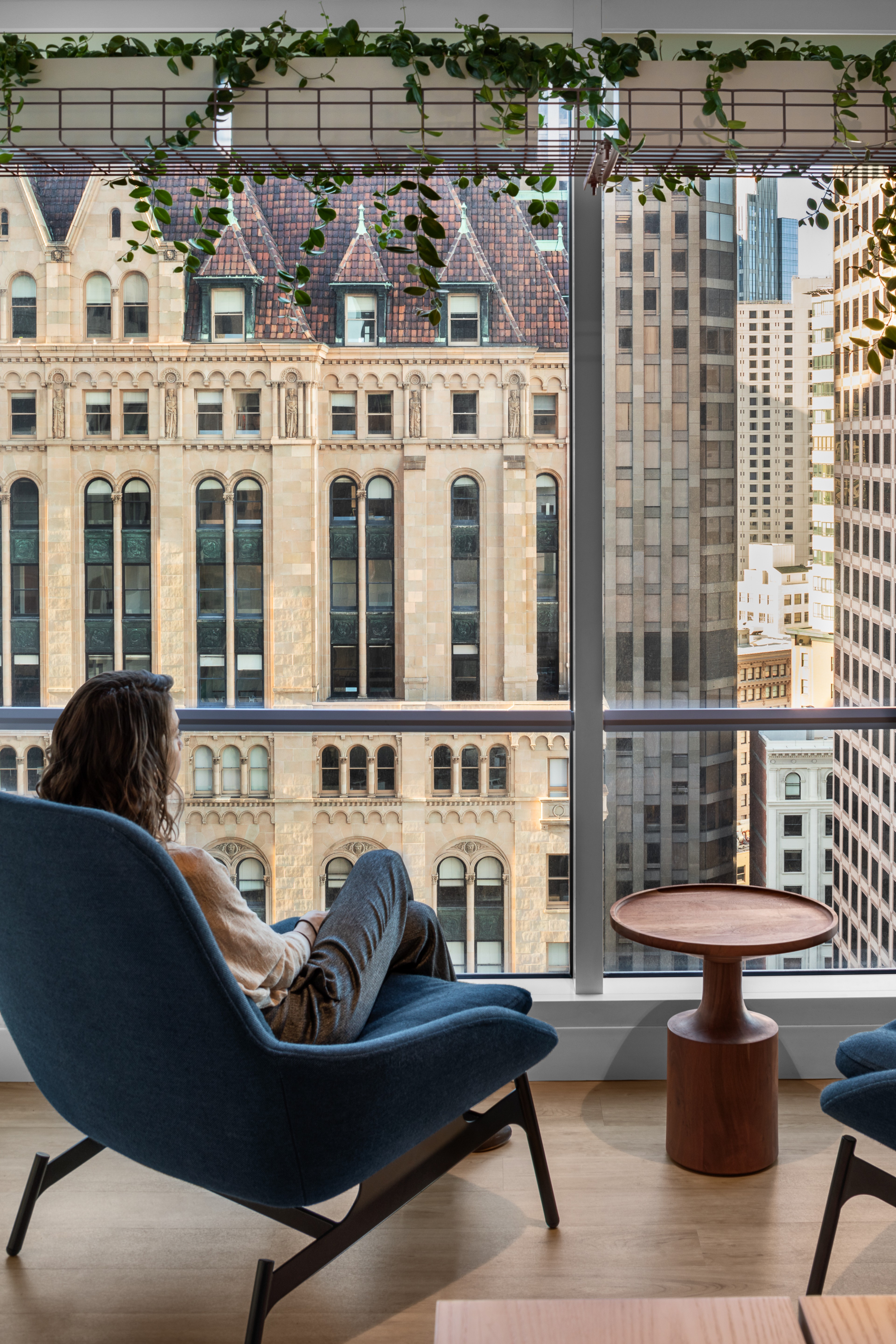 Interior view of 333 Bush with person sitting at a wall of windows